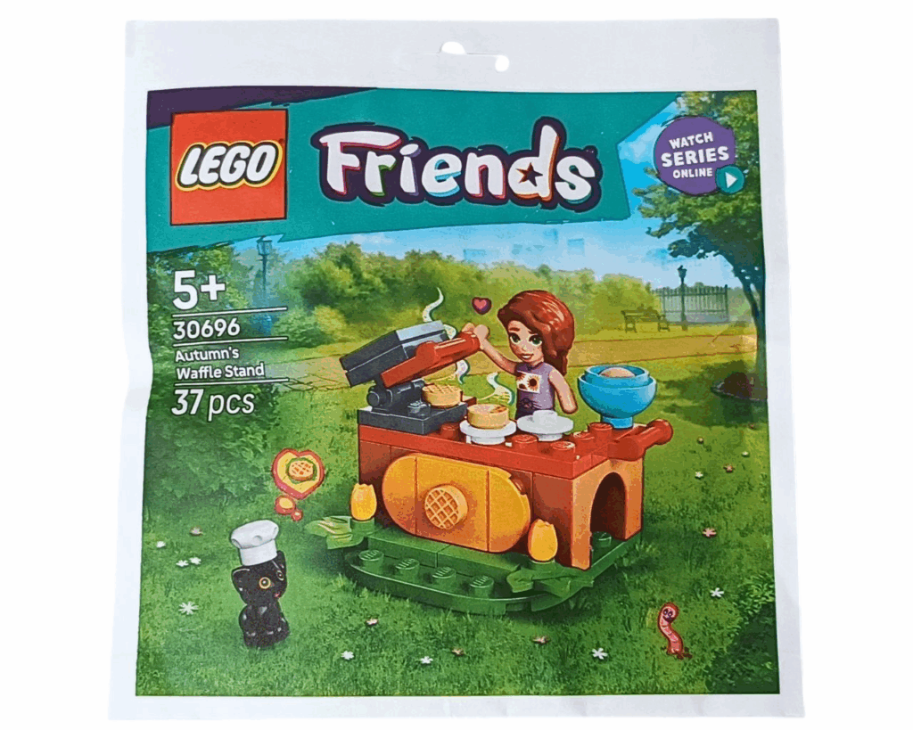 LEGO Friends 30696 オータムのワッフル屋さん」パッケージ画像。公園の芝生の上で、オータムがワッフルを焼き、コック帽をかぶった黒ネコのプルートが見上げているイラストが印刷されている。