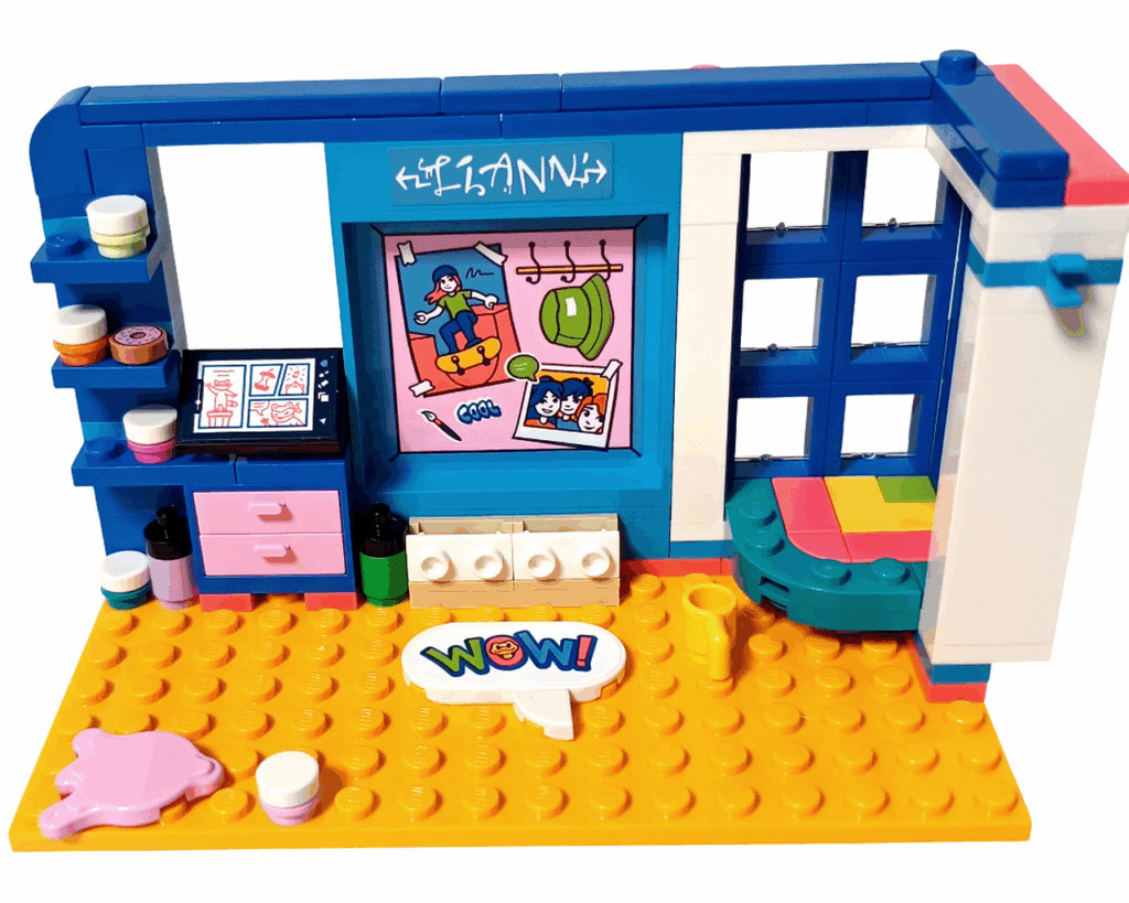 LEGO Friends 41739 リアンの部屋 吹き出しクッション。 黄色の床の中央に「WOW!」と書かれた白い吹き出し型パーツが置かれ、 周囲にピンクの絵の具型パーツやコップがある。