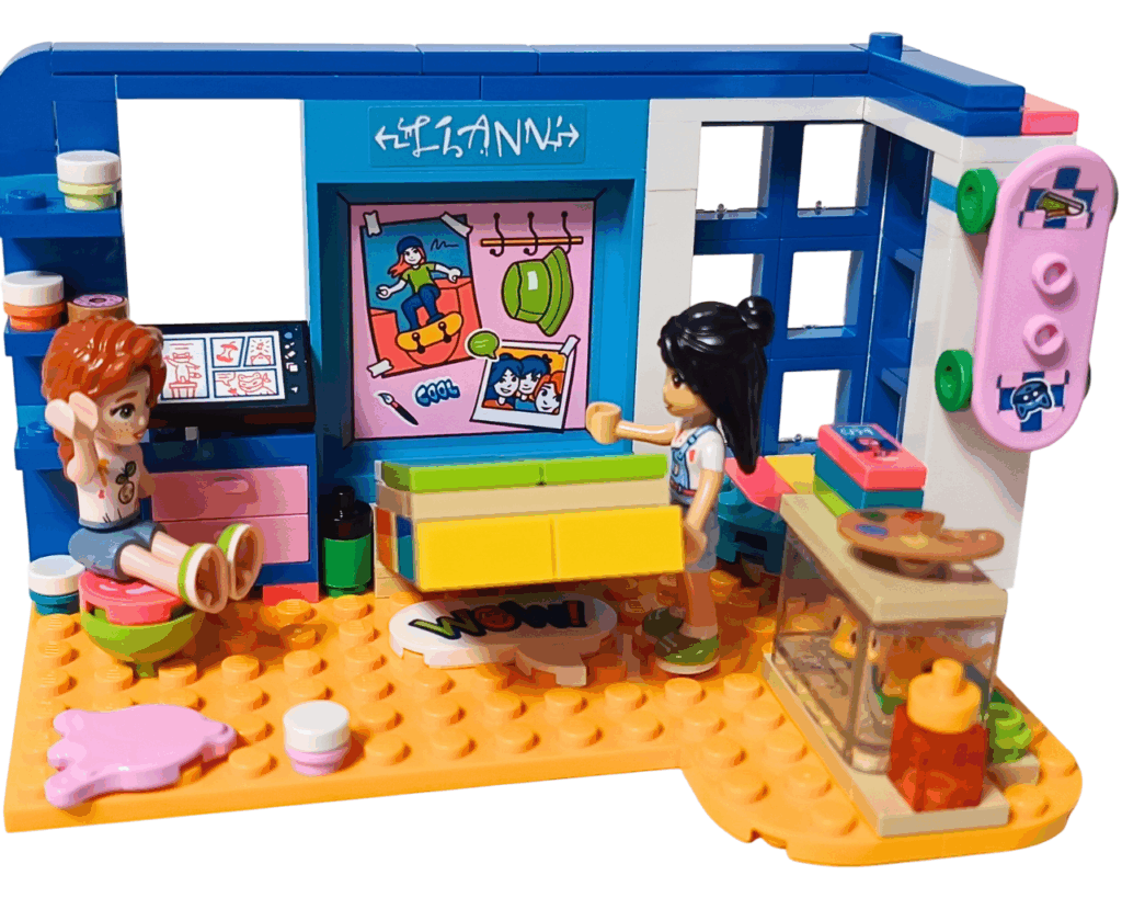 LEGO Friends 41739 リアンの部屋 お泊まり準備シーン。 リアンが壁面収納ベッドを引き出し、オータムがスツールに腰かけて話をしている。 背後にはスケートボードとアートデスク、テラリウムが見える。