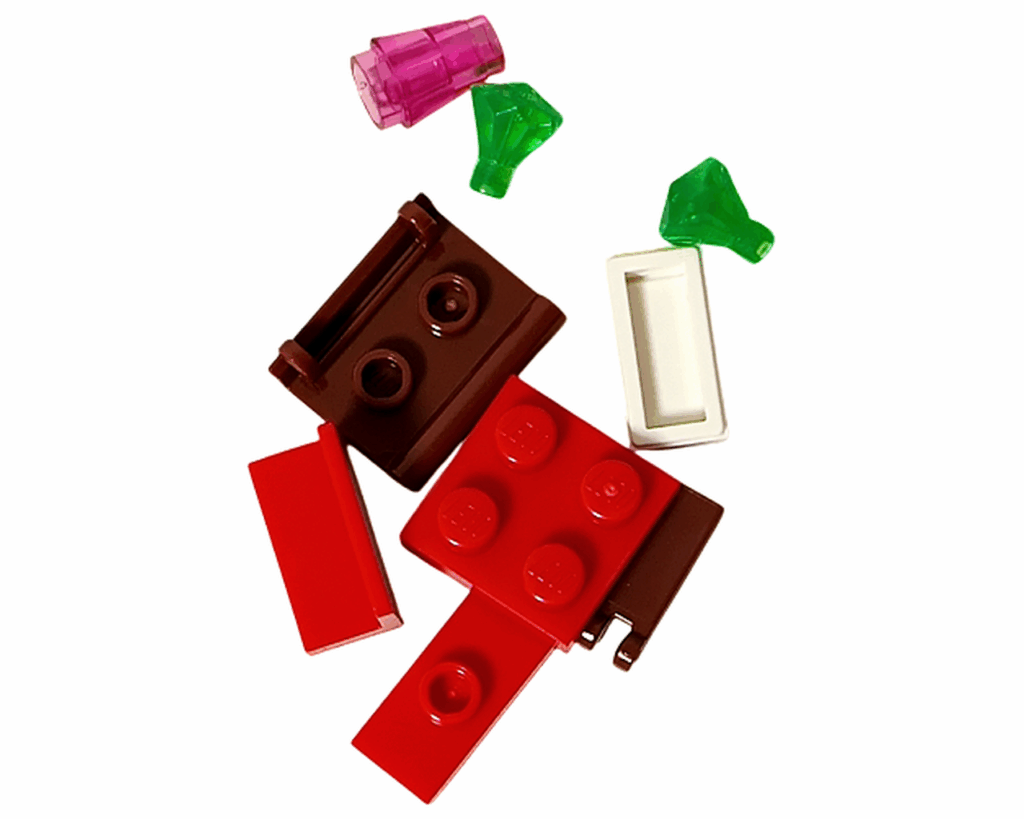 LEGO Friends 42668 4日目のパーツ一覧。ブラウンの本パーツと赤い台座、透明のピンク・グリーンの宝石パーツなど。