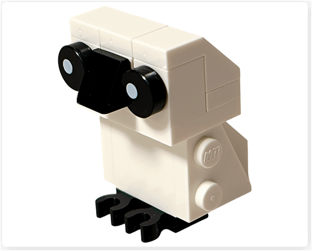 LEGO Harry Potter 76456「ハリー・ポッター アドベントカレンダー2025」ヘドウィグのミニモデル完成。 白いブロックで体と頭部を構成し、黒い丸パーツで目を表現。 足元には黒い爪パーツがあり、立ち姿のフクロウを再現している。