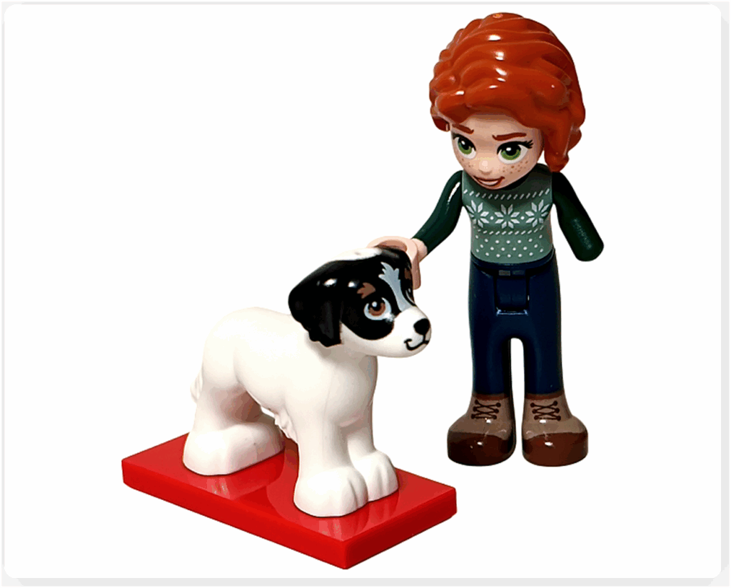 LEGO Friends 41758「アドベントカレンダー2023」9日目のシーン。オータムのミニドールが白い犬デイジーを撫でている情景。赤いスタンドに立ち、冬の広場でのやさしいひとときを表現したカットです。