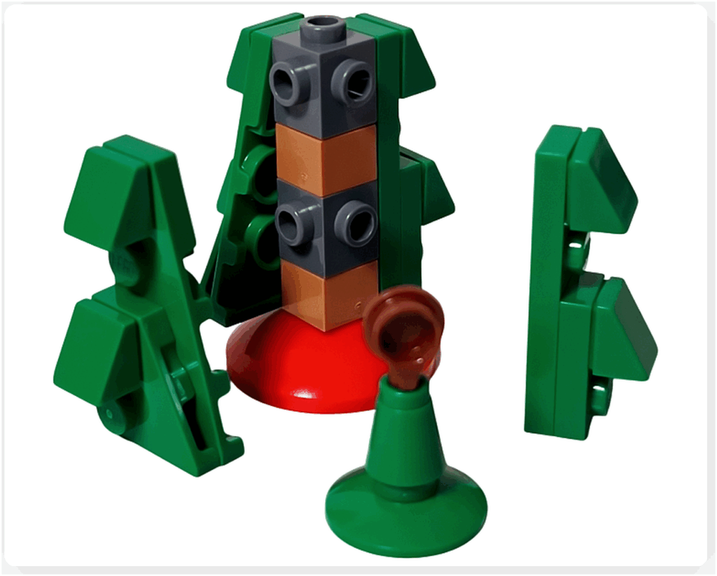 LEGO Friends 41758「アドベントカレンダー2023」12日目の組立途中。赤い台座に幹パーツを積み上げ、周囲に緑の三角スロープを取り付けてクリスマスツリーの形が見え始めた段階です。