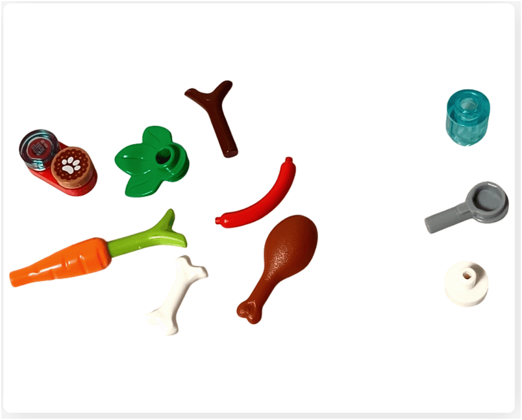 LEGO Friends 41758 17日目の組立途中。にんじん、骨、葉パーツ、ドラムスティック、缶詰、小物パーツが用途ごとに分けて並べられている様子。