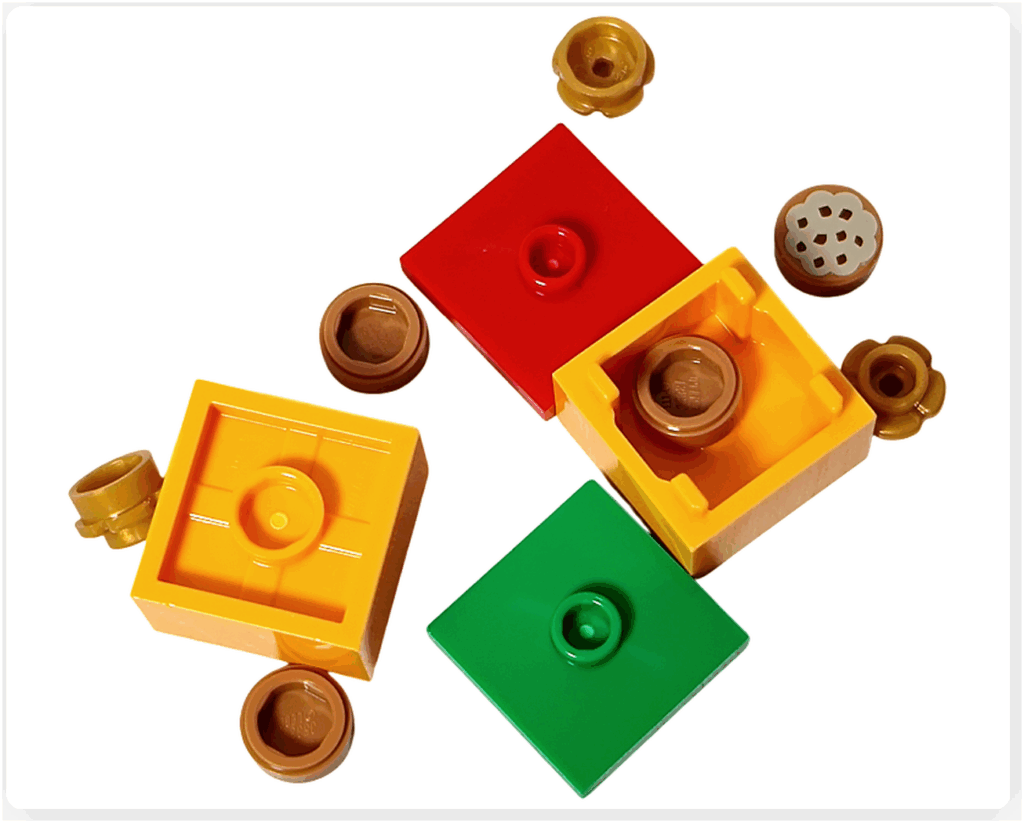 LEGO Friends アドベントカレンダー2023 19日目のパーツ。赤・黄色・緑のプレート、ボックス形状のパーツ、丸い1×1パーツなどギフトボックス用の部品。