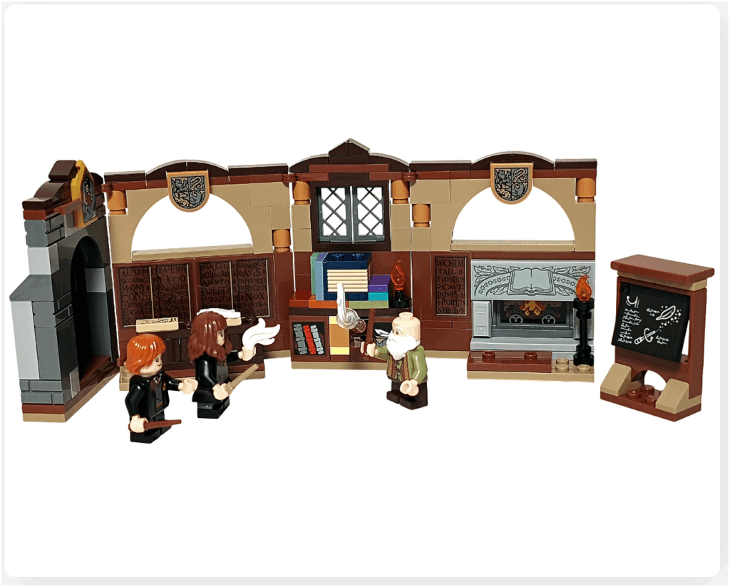 レゴ ハリー・ポッター 76442「呪文学の教室」セットの全体シーン。中央でフリットウィック先生とハーマイオニー、ロンが呪文の練習をしており、羽根がふわりと浮かぶ様子が再現されている。教室の壁面・黒板・暖炉・本棚が並び、セット全景がわかる構図。