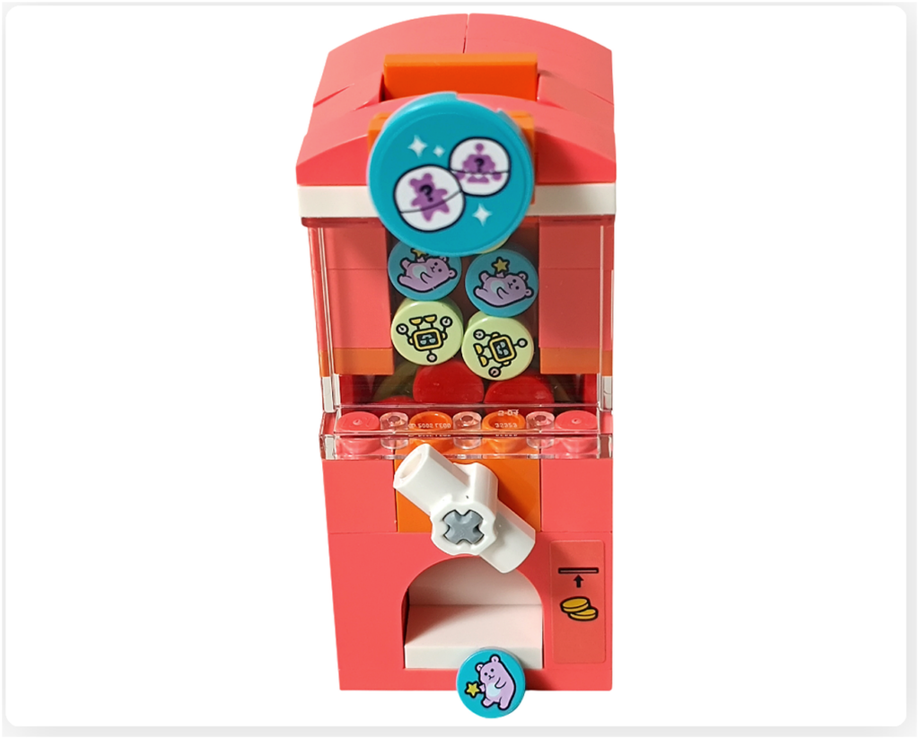 レゴ フレンズ 42674 カプセルマシンのギミック作動。ダイヤルを回して取り出し口からメダルが1枚出てきた状態。