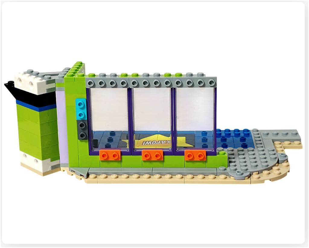 レゴ フレンズ 42674 組立レビュー第2部の1階コミックショップウィンドウ写真。フレーム付きの窓パーツを壁に取り付け、正面ウィンドウを配置した状態。