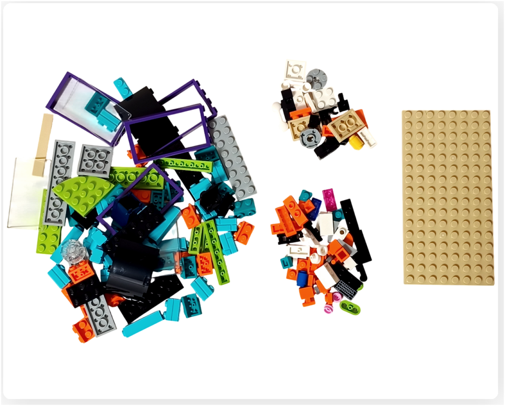 レゴ フレンズ 42674 コミックショップとゲームセンターの袋7パーツ。2階エリアの組立に使用されるカラフルなブロックや小物パーツ、ベースプレートが並べられている様子。