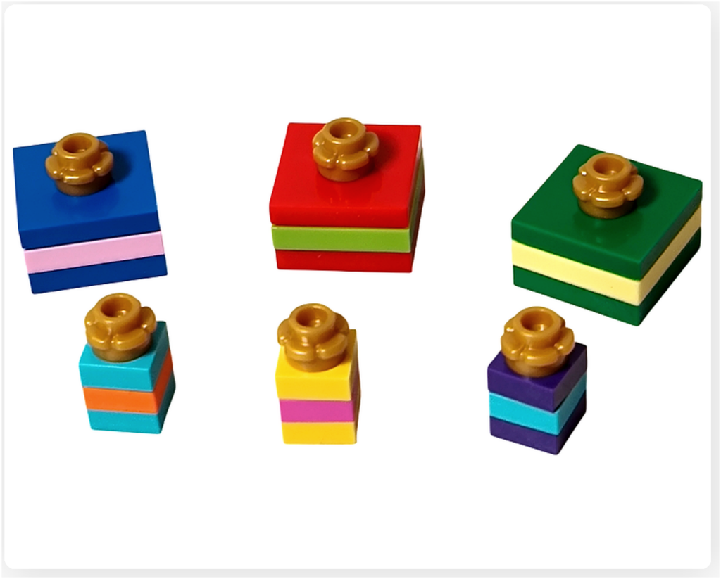 レゴ 40746 シーズナル クリスマスプレゼント配達トラックの付属パーツで作るプレゼント一式。大小のカラフルな箱に金色の飾りが付いたデザインで、ギフト用ブロックの形状や配色が分かる写真です。