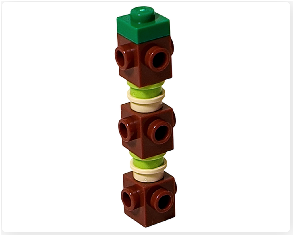 レゴ 40746 シーズナル クリスマスプレゼント配達トラックに含まれるクリスマスツリーの幹部分。複数の茶色ブロックを積み重ね、中央に装飾パーツを挟みながら上部まで積み上げた芯が完成した写真です。