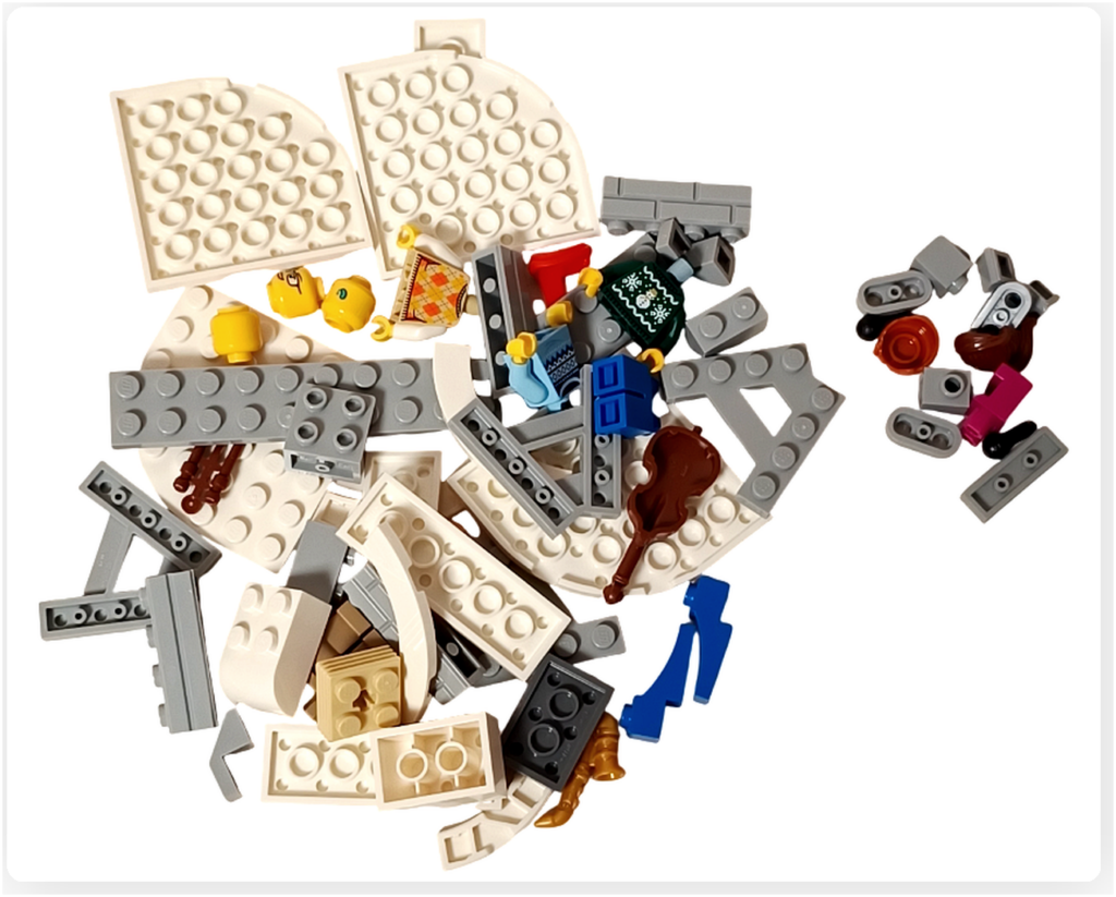 レゴ 40778 雪のあずまや(Winter Gazebo)の組立パート袋1の内容。白やグレーを中心とした要素とミニフィグの一部が含まれている。