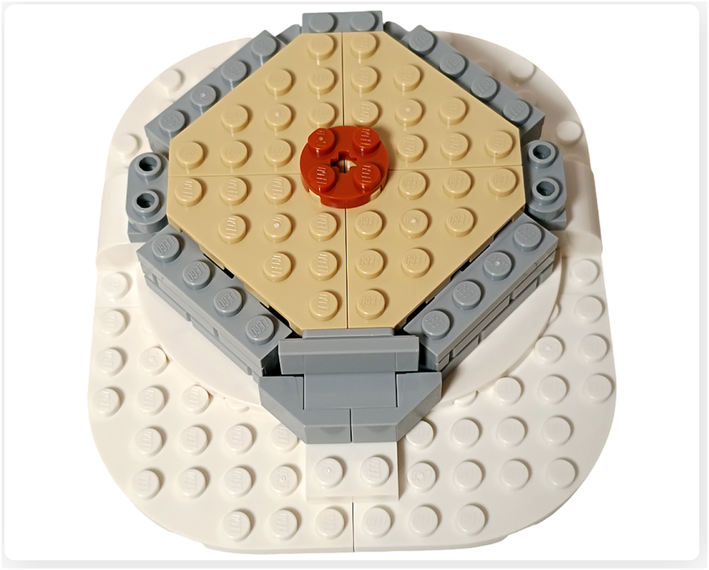 レゴ 40778 雪のあずまや(Winter Gazebo)の組立途中の床板。円形ベース中央にベージュ色の床パネルが敷かれ、中央に装飾用パーツが配置されている。