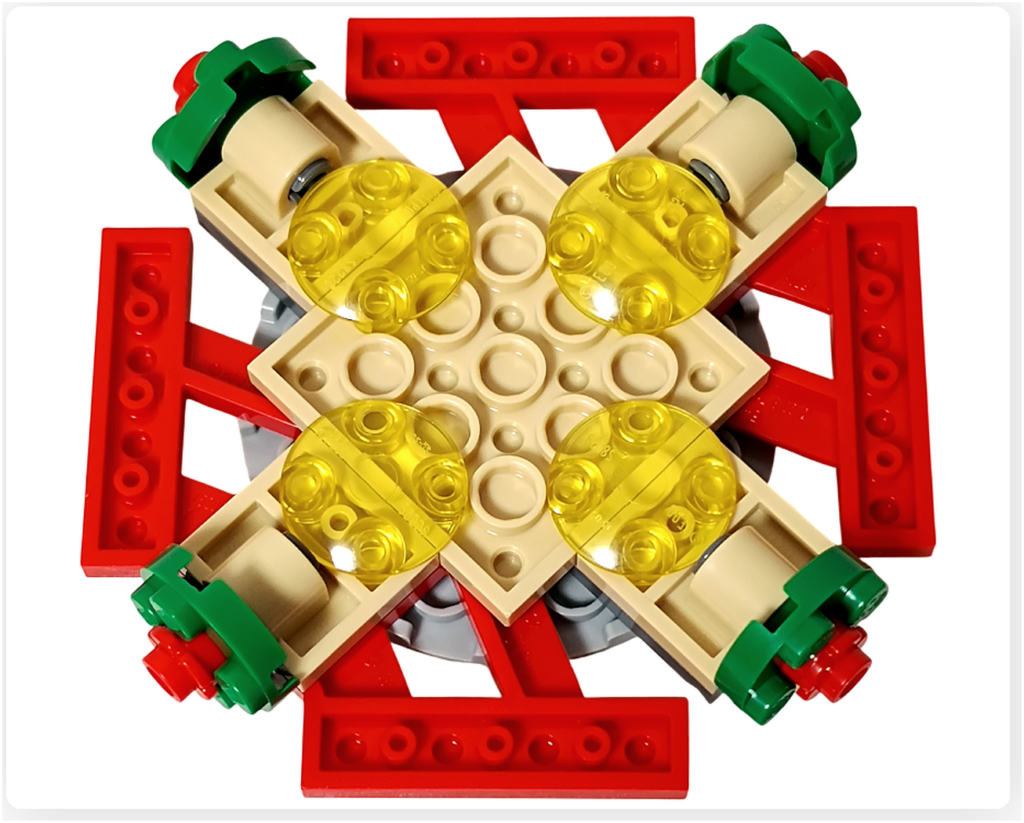 レゴ 40778 雪のあずまや(Winter Gazebo)の天井裏側。ベージュの中心プレートを囲むように、黄色の半透明パーツが4つ配置され、内部照明の構造がわかる様子。