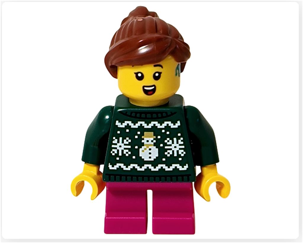 レゴ 40778 雪のあずまや（Winter Gazebo）に含まれる歌い手ミニフィグの正面。雪だるま柄のグリーンのセーターとピンクのパンツを身に着け、口を開いた明るい表情が確認できる。