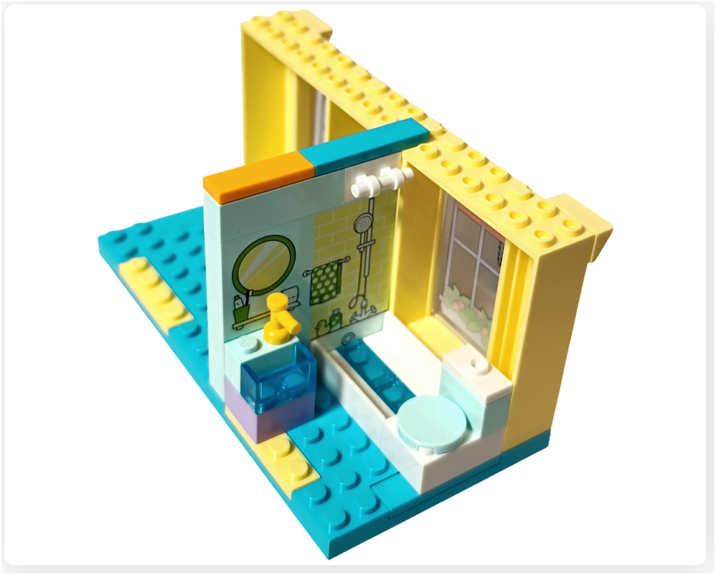 レゴ フレンズ 41724「ペイズリーのおうち」浴室に設置されたシャンプーなどの小物パーツ。透明パーツと黄色のアクセサリーが配置されている。