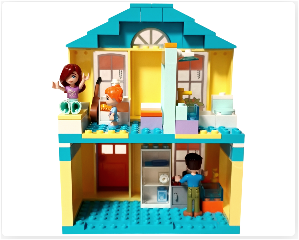 レゴ フレンズ 41724 「ペイズリーのおうち」の完成シーン。1階で料理をするジョナサンと、2階でエラに起こされるペイズリー。ベッド横にはギターが置かれている朝の家族の様子。