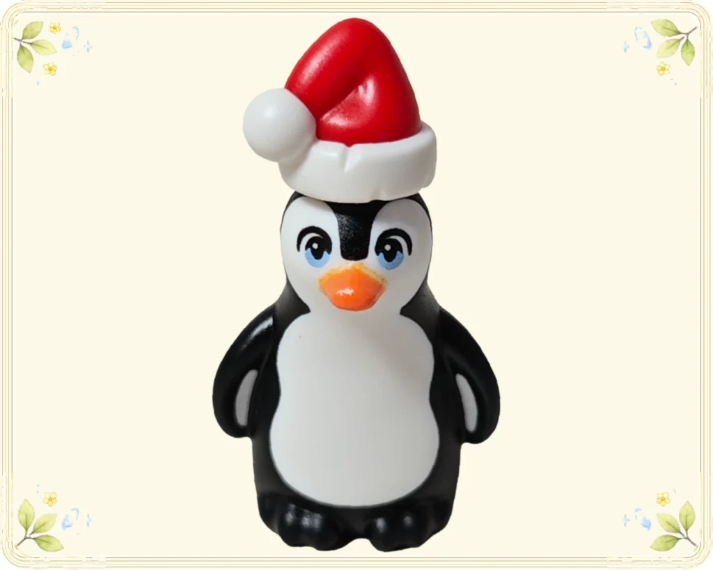 レゴ フレンズ 42698 サンタ帽のペンギンの正面 青い瞳とオレンジ色のくちばし、白いお腹が見える姿
